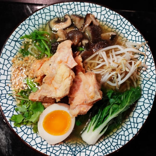 MISO Ramen bowl with crispy chicken, mushrooms, bean sprouts, bok choy, and a soft-boiled egg.