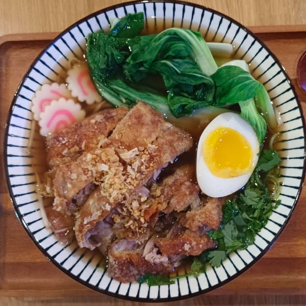 MISO Ramen with crispy fried pork, bok choy, fish cakes, and a soft-boiled egg.