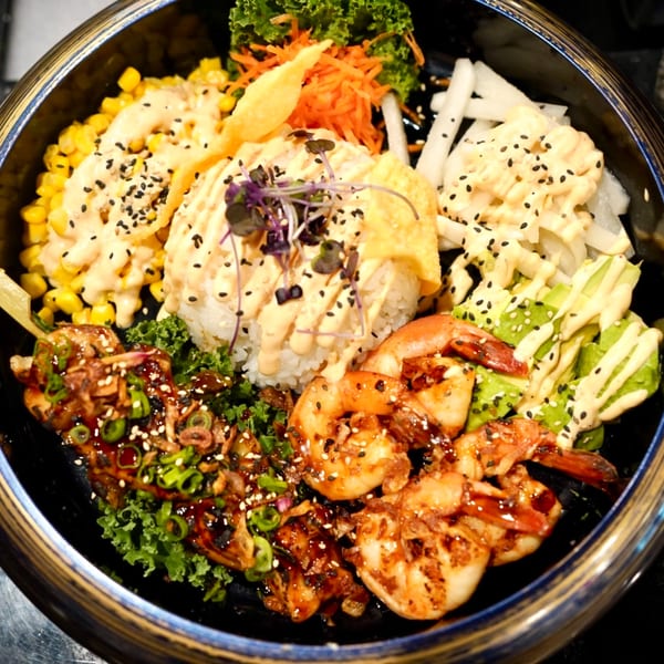 MISO Ramen and Poke Bar's colorful poke bowl with shrimp, chicken, rice, corn, avocado, and vegetables.